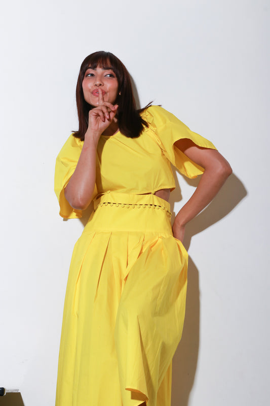 Yellow dress with a buttoned waist and box pleat.