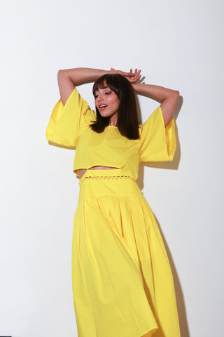 Yellow dress with a buttoned waist and box pleat.