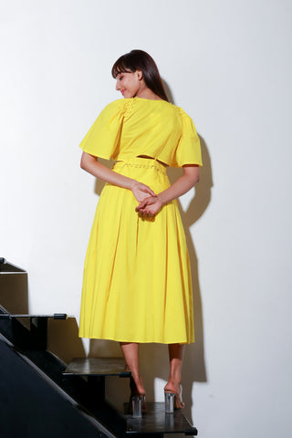 Yellow dress with a buttoned waist and box pleat.