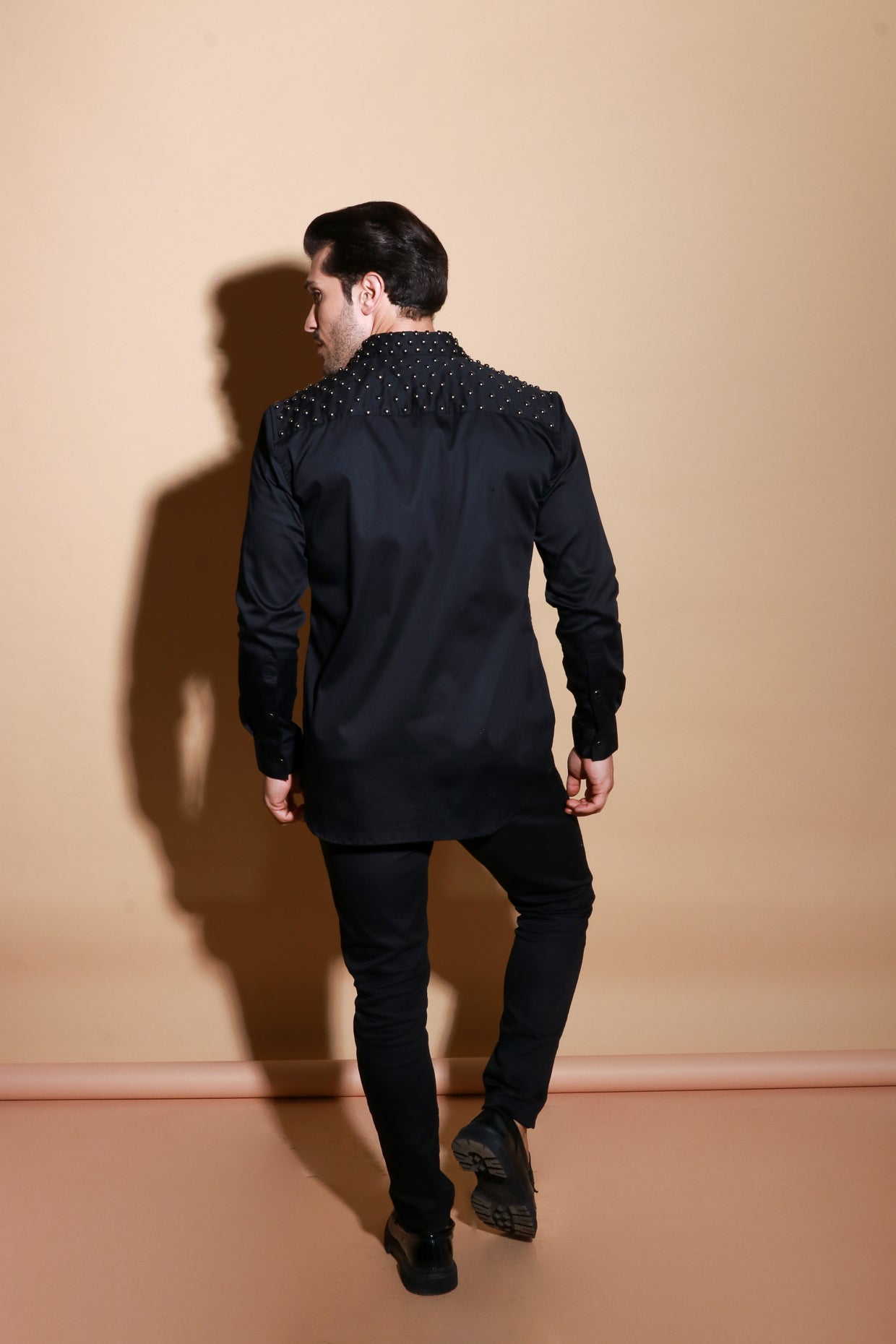 Black full sleeve shirt with muted stud detailing .