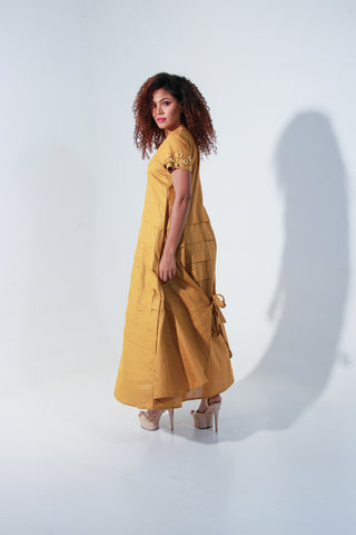 Ochre yellow maxi A-line dress with self panels and a tie-up detail at the back.