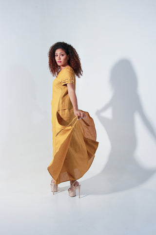 Ochre yellow maxi A-line dress with self panels and a tie-up detail at the back.