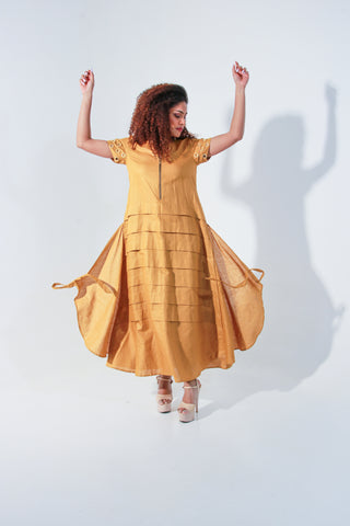 Ochre yellow maxi A-line dress with self panels and a tie-up detail at the back.