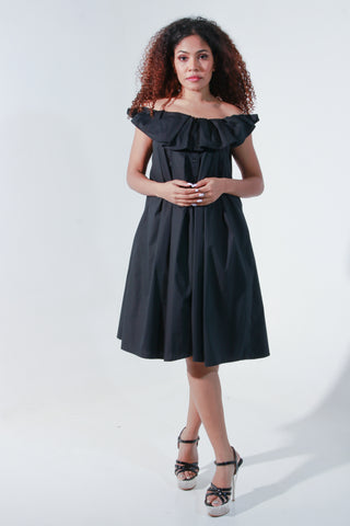 Black off shoulder knee length dress with pleated neck detailing.