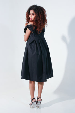 Black off shoulder knee length dress with pleated neck detailing.