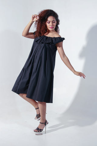 Black off shoulder knee length dress with pleated neck detailing.