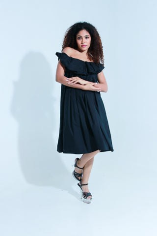 Black off shoulder knee length dress with pleated neck detailing.