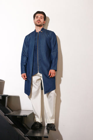 Denim zippered waist coat with self detailing and attached jacket paired with narrow off white pants.