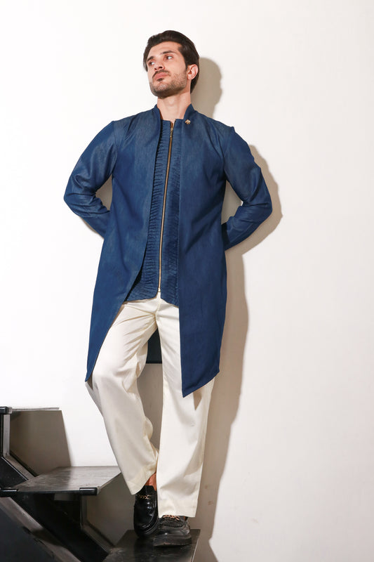 Denim zippered waist coat with self detailing and attached jacket paired with narrow off white pants.