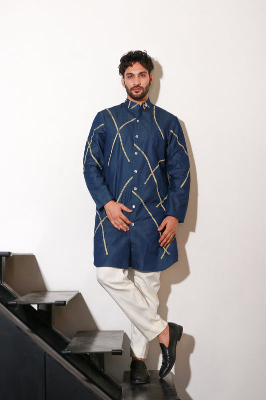 Denim knee length kurta with abstract crepe print detailing and off white narrow pants.