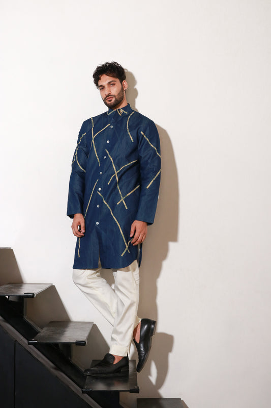 Denim knee length kurta with abstract crepe print detailing and off white narrow pants.