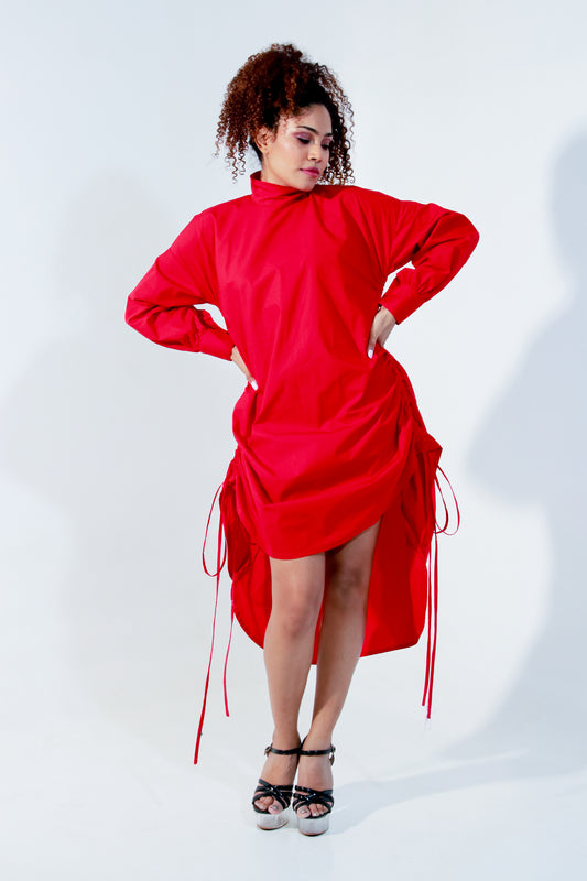 Red top doubles up as a short dress and features a high collar and pull up detailing on the front.