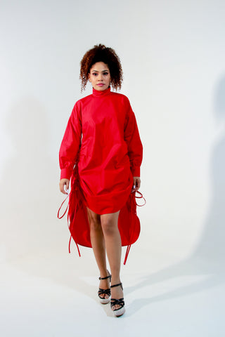 Red top doubles up as a short dress and features a high collar and pull up detailing on the front.