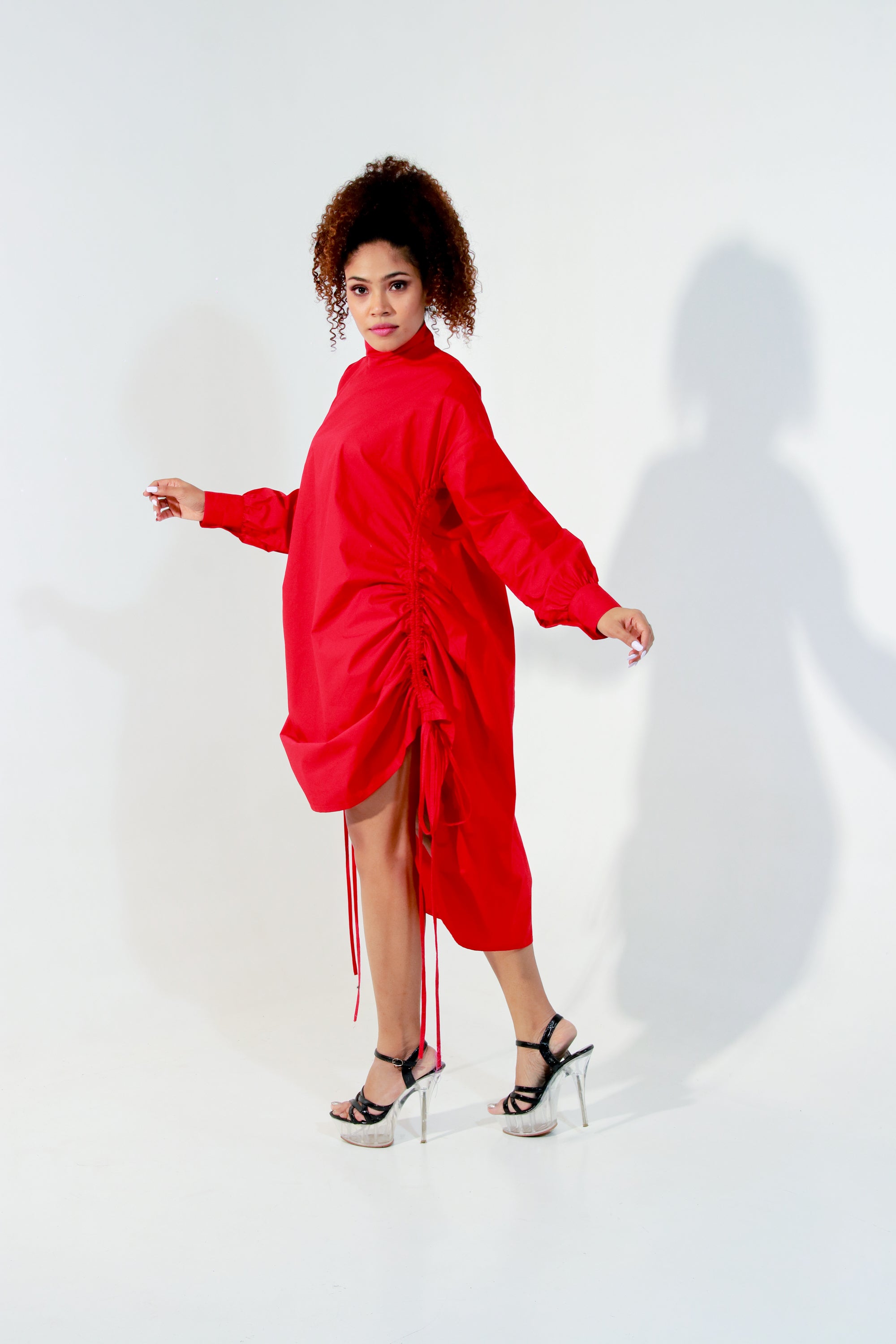 Red top doubles up as a short dress and features a high collar and pull up detailing on the front.