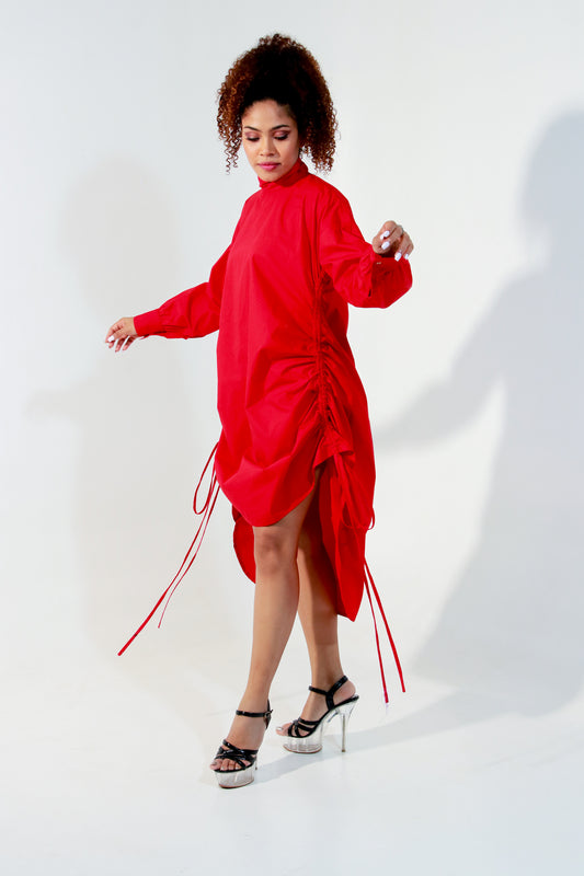 Red top doubles up as a short dress and features a high collar and pull up detailing on the front.