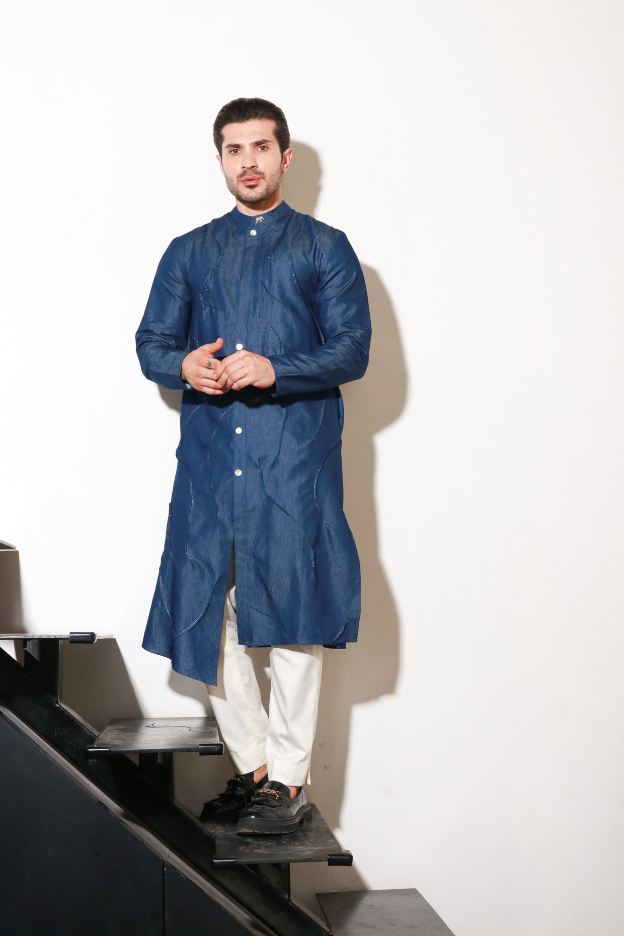 Denim long kurta with self pleating detailing paired with off white narrow pants.