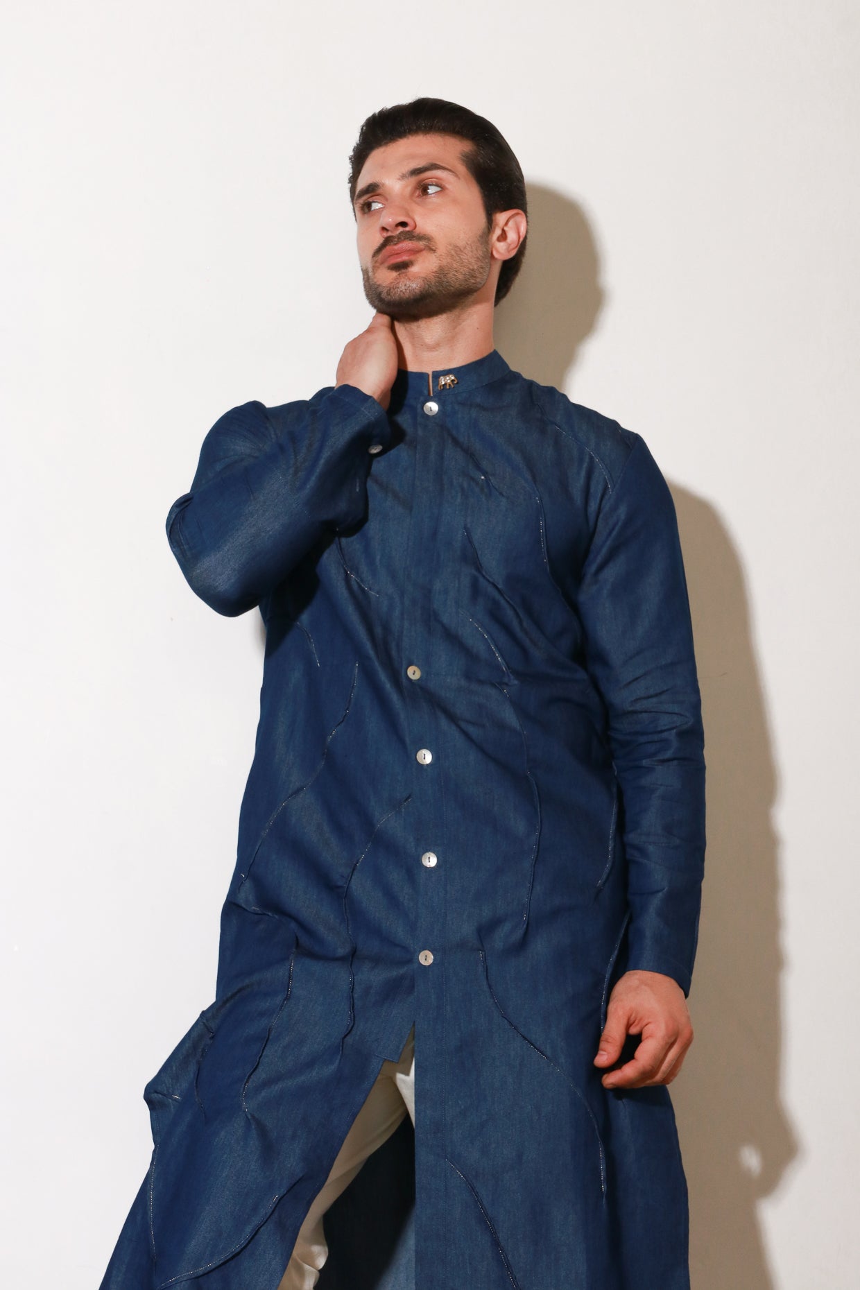 Denim long kurta with self pleating detailing paired with off white narrow pants.
