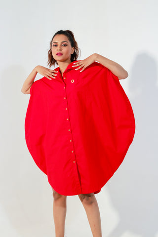 Red circle dress features one pocket & a golden eyelet.