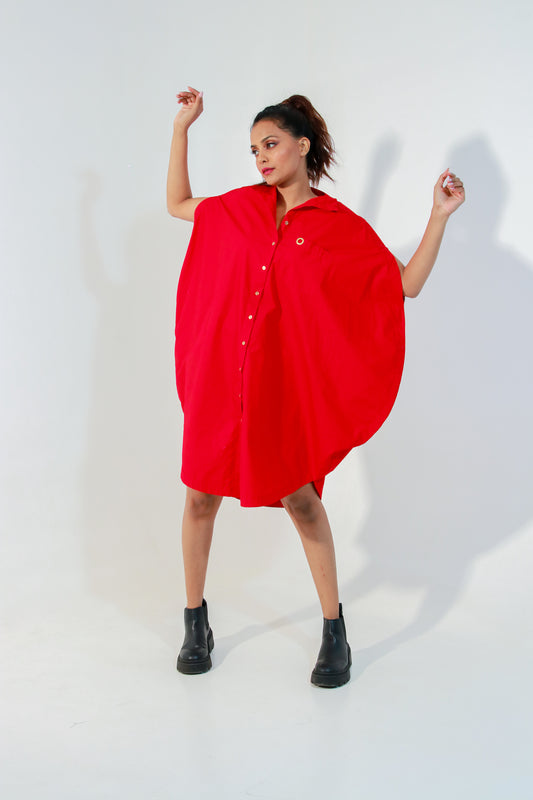 Red circle dress features one pocket & a golden eyelet.