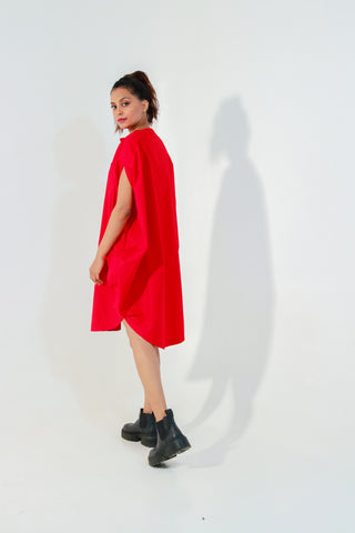 Red circle dress features one pocket & a golden eyelet.