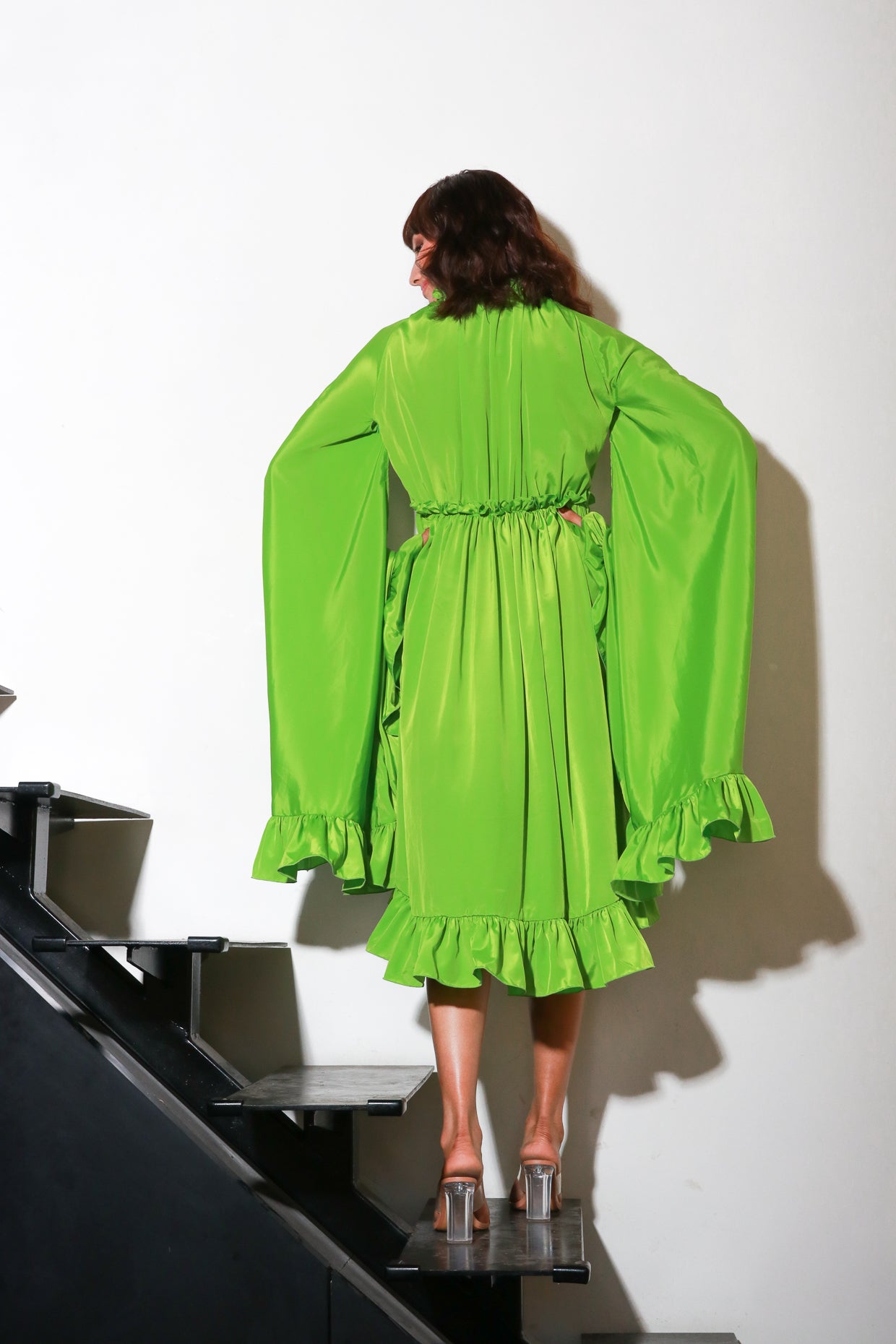 Green French crepe flared midi- dress with cape sleeves.