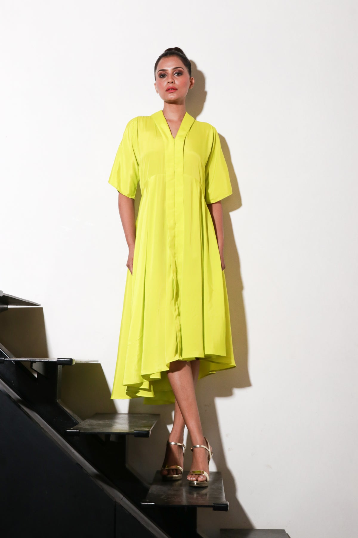 Yellow French crepe dress with flared center and back feature.