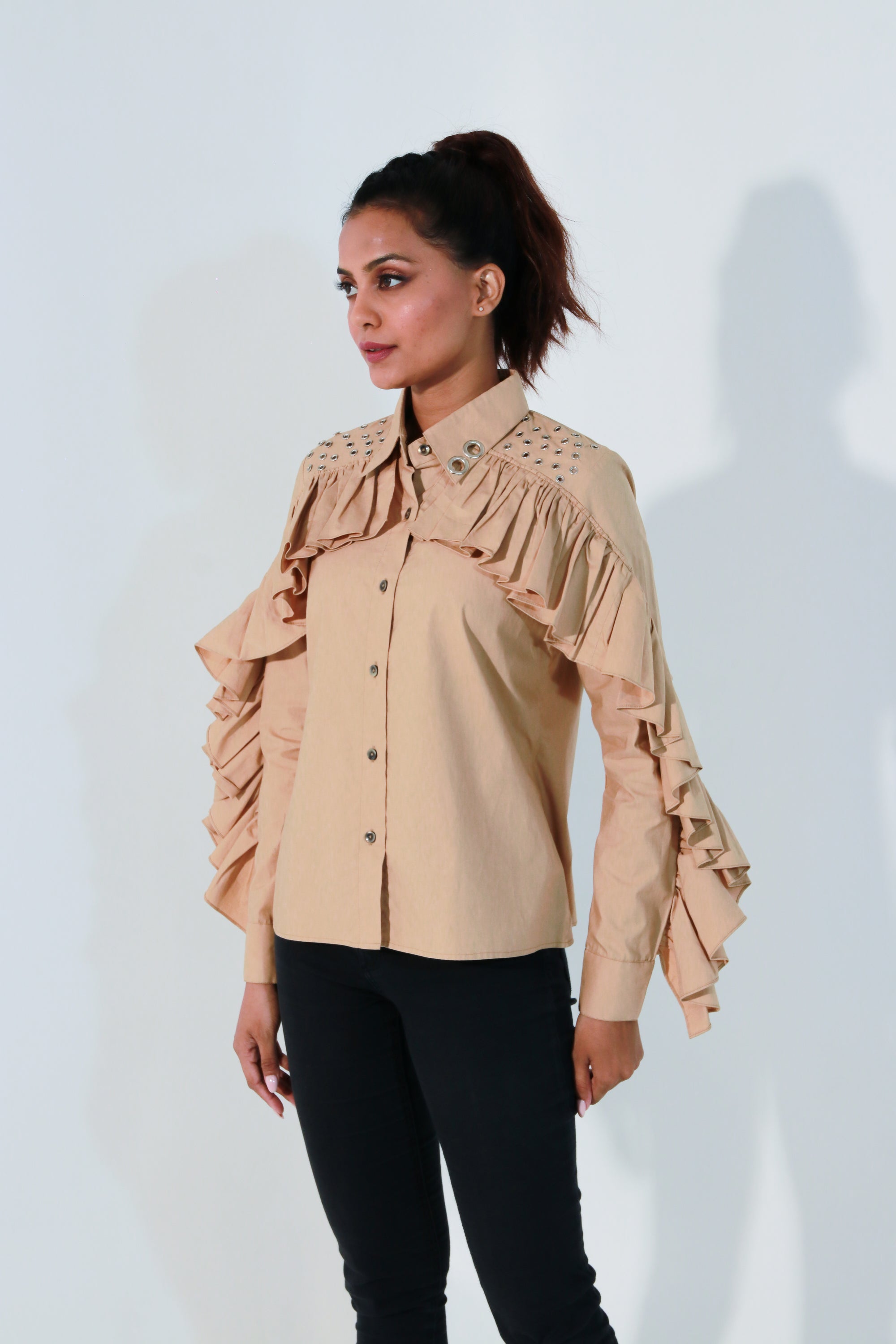 Khaki shirt features ruffles with eyelet detailing on the shoulders and collar.