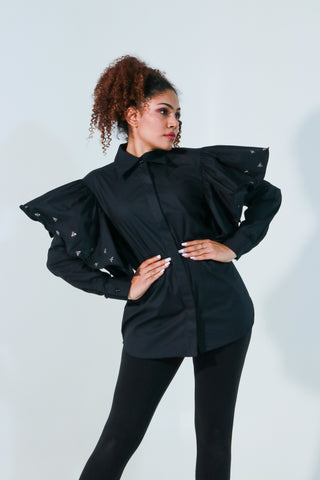 Black shirt features with bee embellishments and frill on the sleeves.