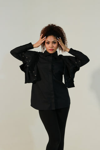 Black shirt features with bee embellishments and frill on the sleeves.