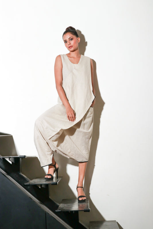 Ecru asymmetric sleeveless jumpsuits.