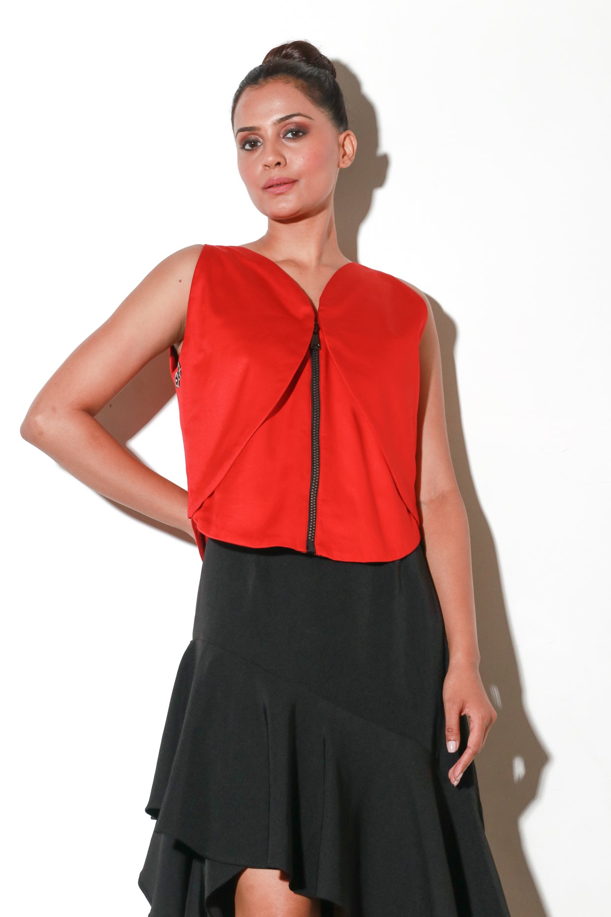 Sleeveless zippered red geometric flap crop top.