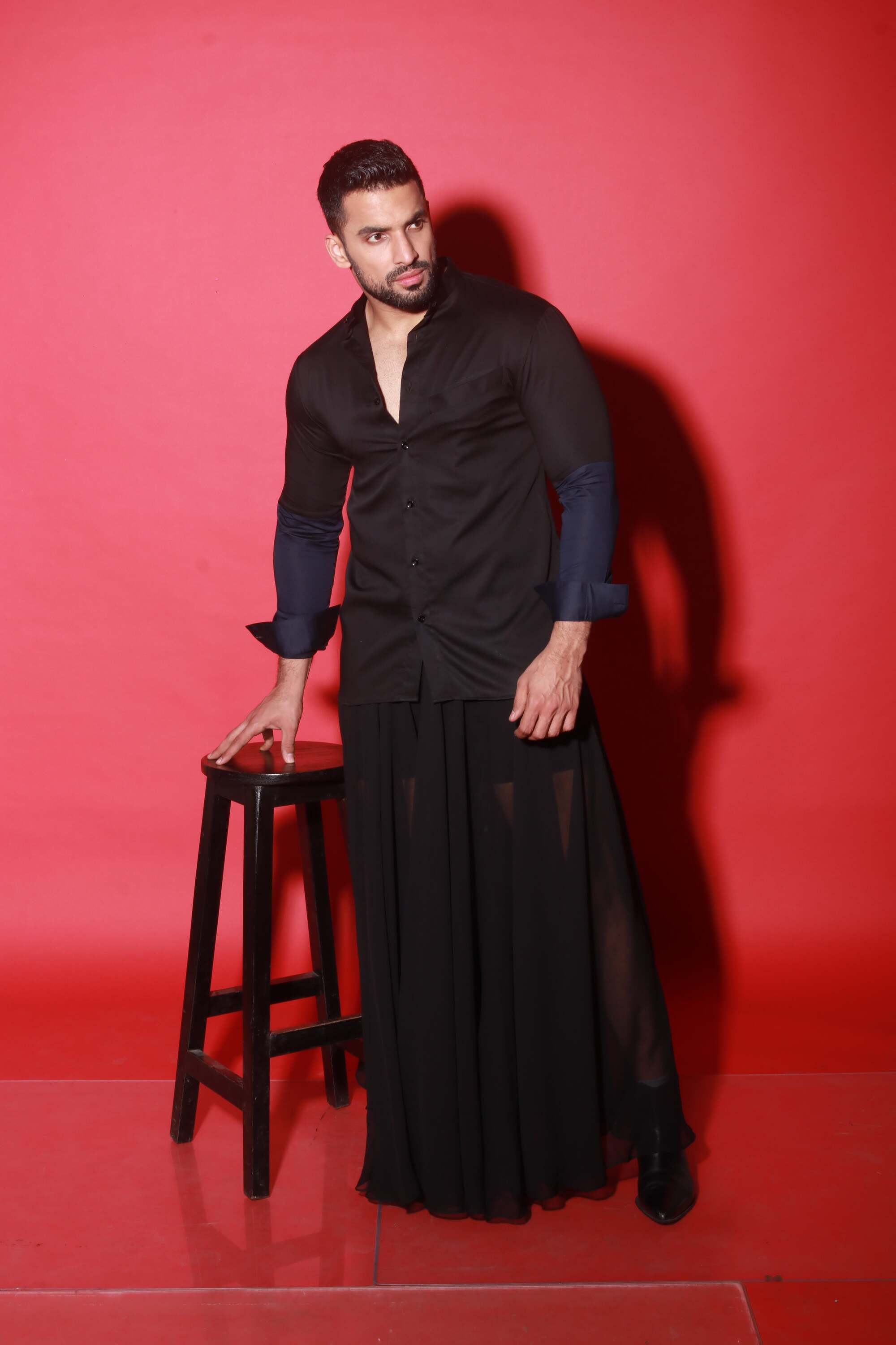 Chinese collar black shirt with blue quilting feature.