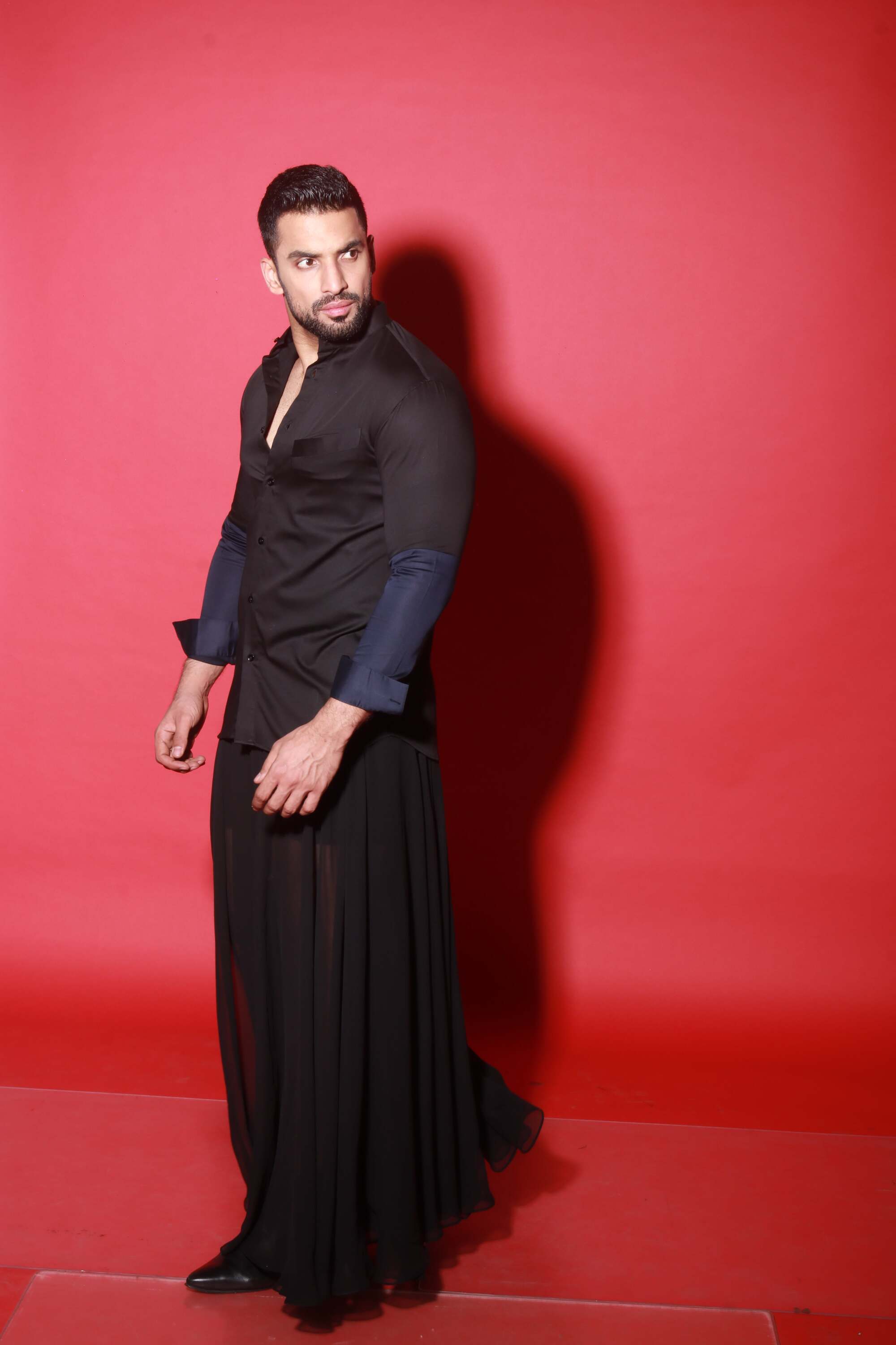 Chinese collar black shirt with blue quilting feature.