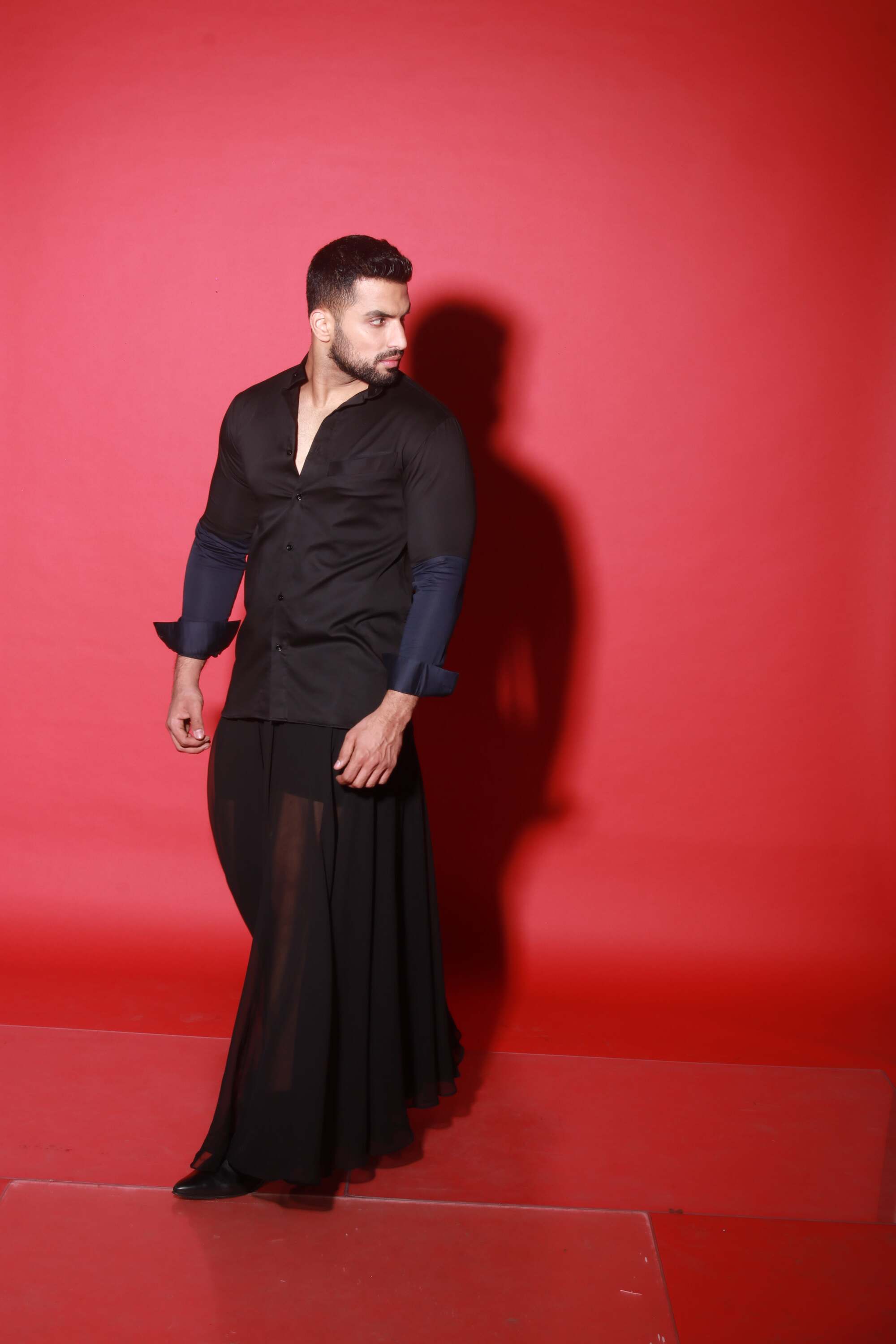 Chinese collar black shirt with blue quilting feature.