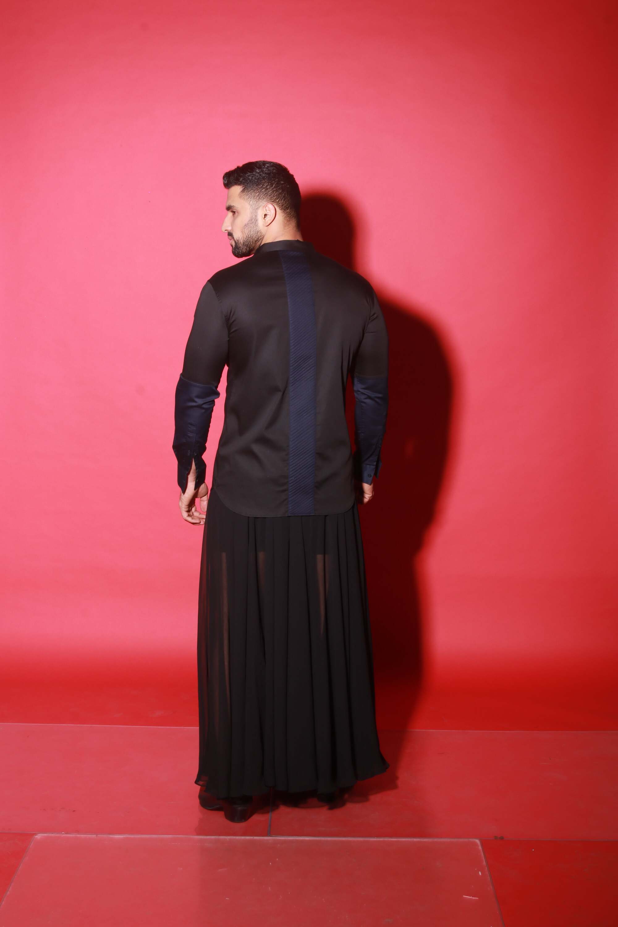 Chinese collar black shirt with blue quilting feature.