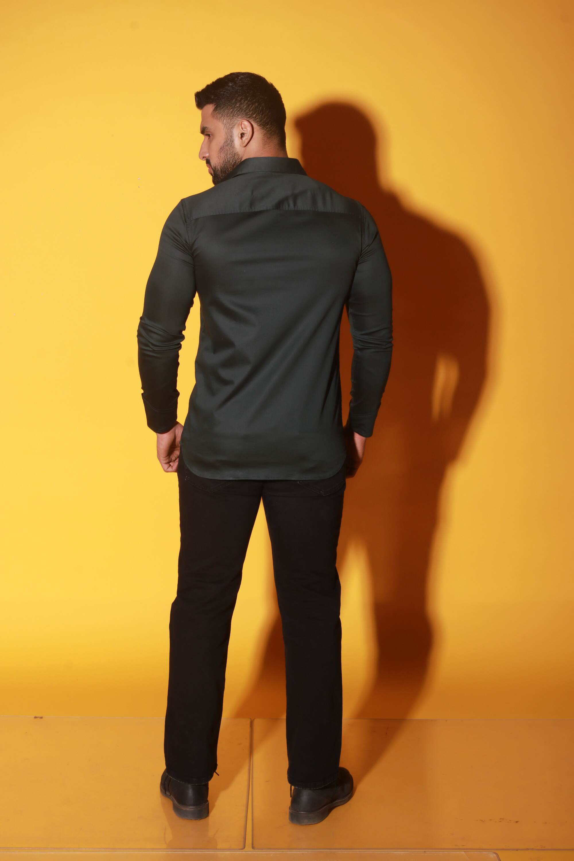 Green shirt with black detailing and diagonal pockets.