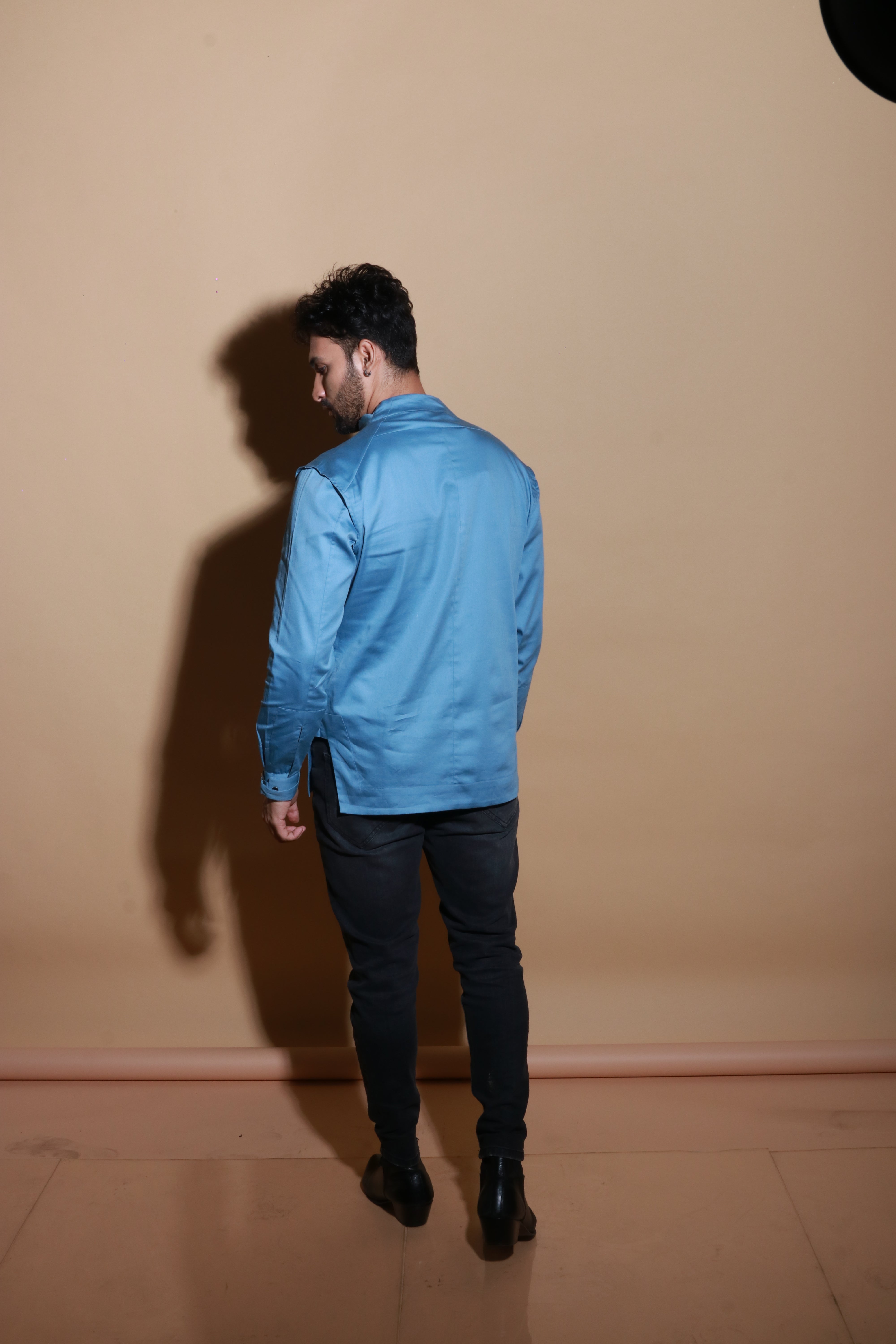 Slate blue shirt with extended pockets and zipper feature.