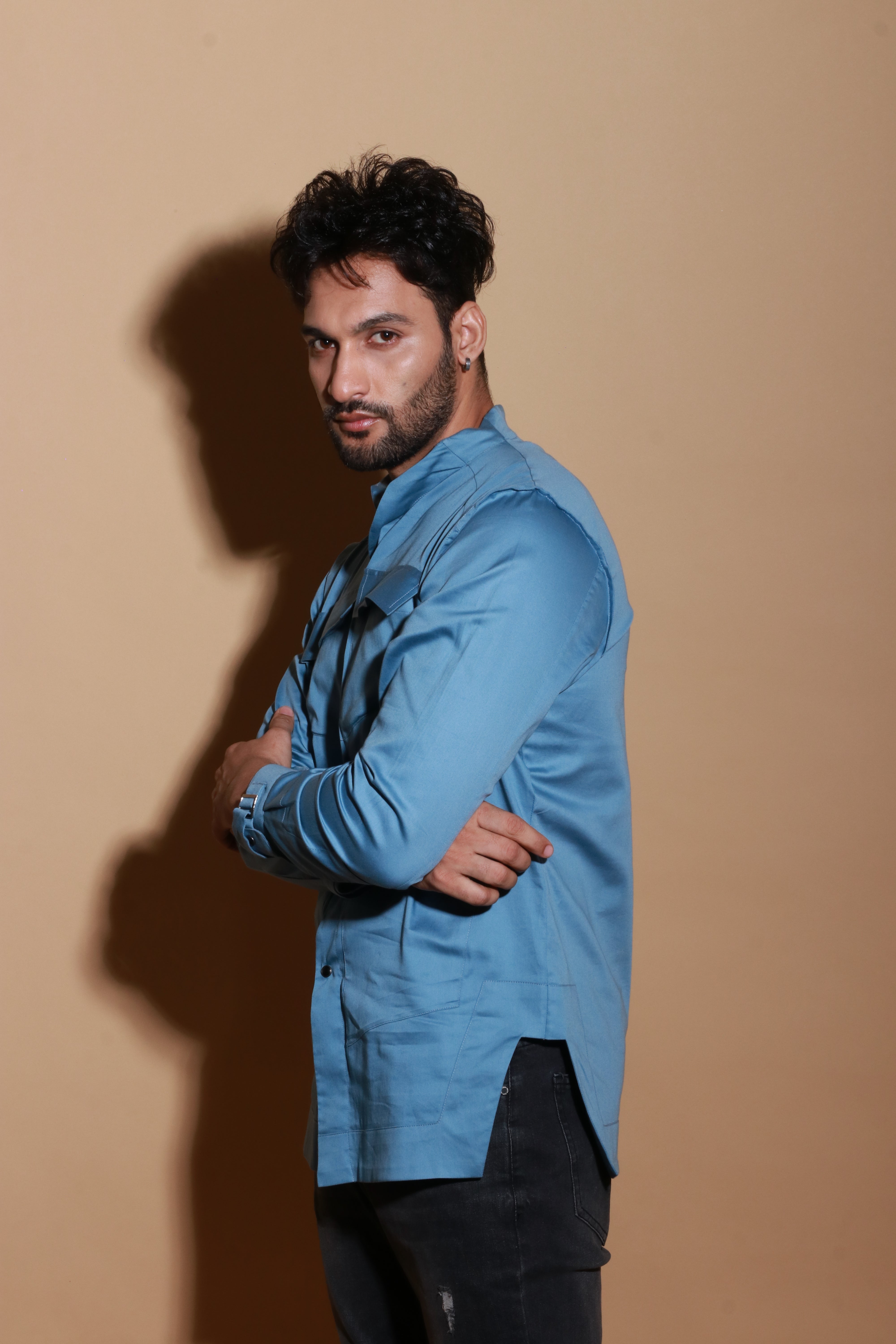 Slate blue shirt with extended pockets and zipper feature.