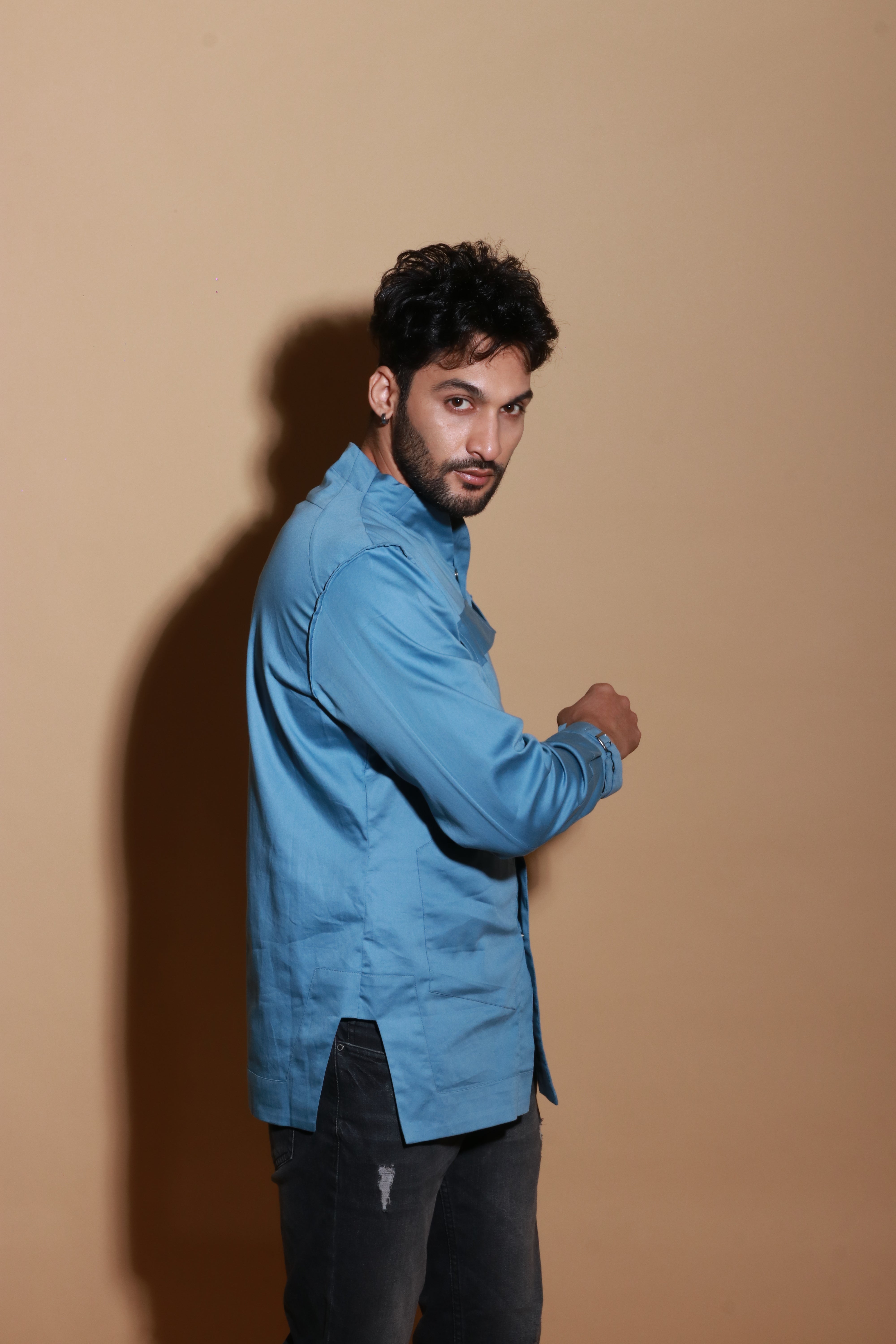 Slate blue shirt with extended pockets and zipper feature.