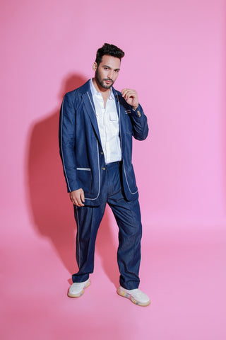 Denim jacket paired with wide legged pants with white piping detailing.