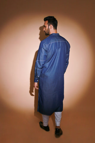 Denim long kurta with contrast stitch detailing and narrow white pants .