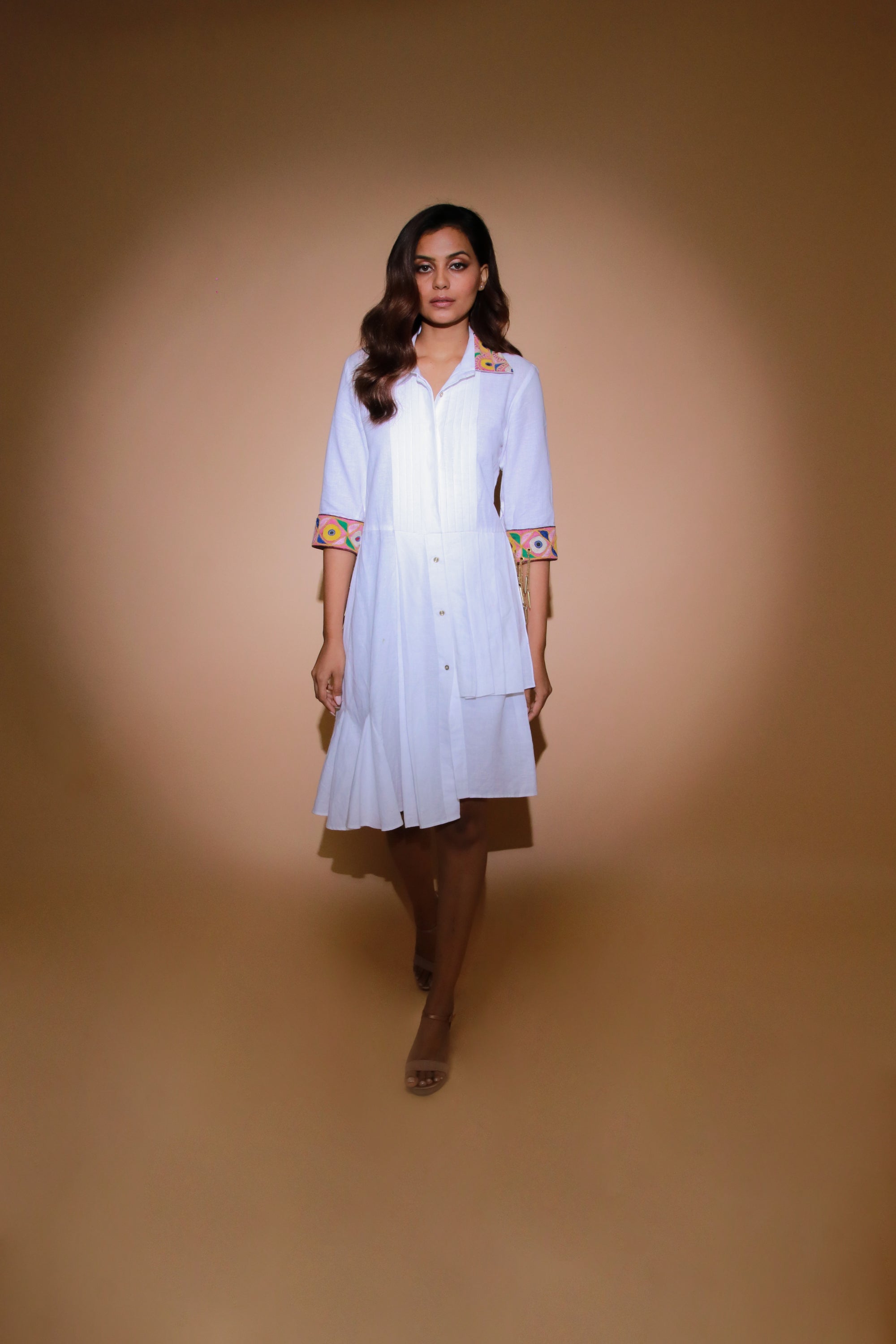 White shirt dress features a pleated yoke with Kutch border on collar and cuffs.