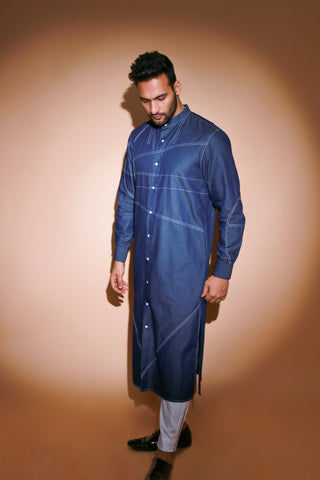 Denim long kurta with contrast stitch detailing and narrow white pants .