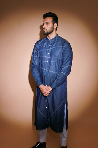 Denim long kurta with contrast stitch detailing and narrow white pants .