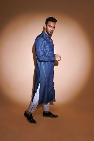 Denim long kurta with contrast stitch detailing and narrow white pants .