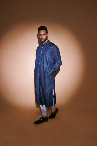 Denim long kurta with contrast stitch detailing and narrow white pants .