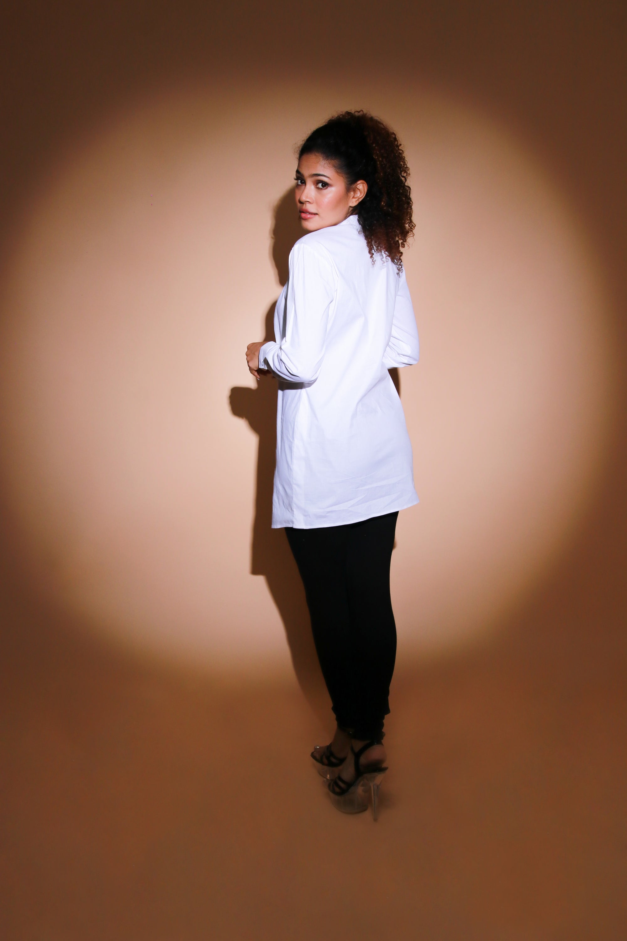 White top features an open side flap and eyelet and chains embellishment.