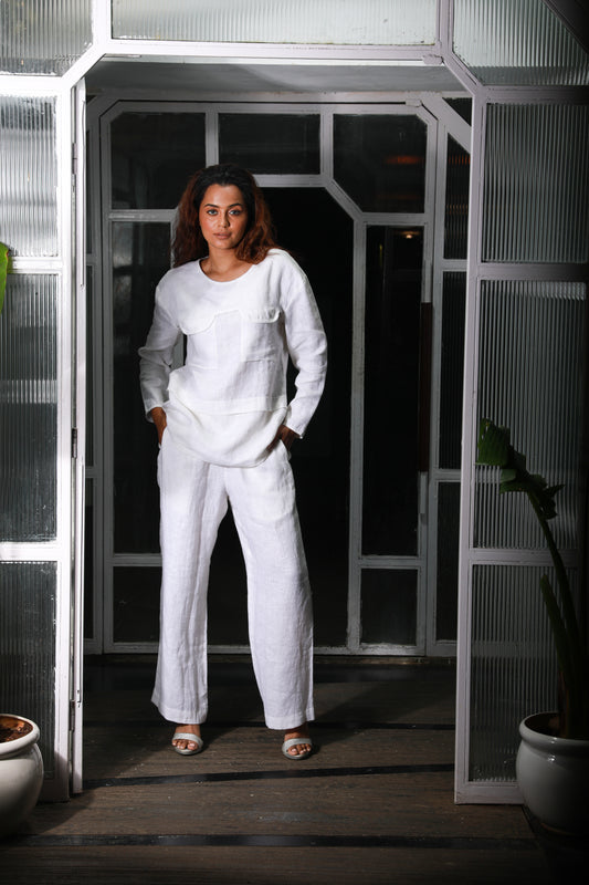 White linen co-ord set features a top with two pocket detailing and matching straight pants.