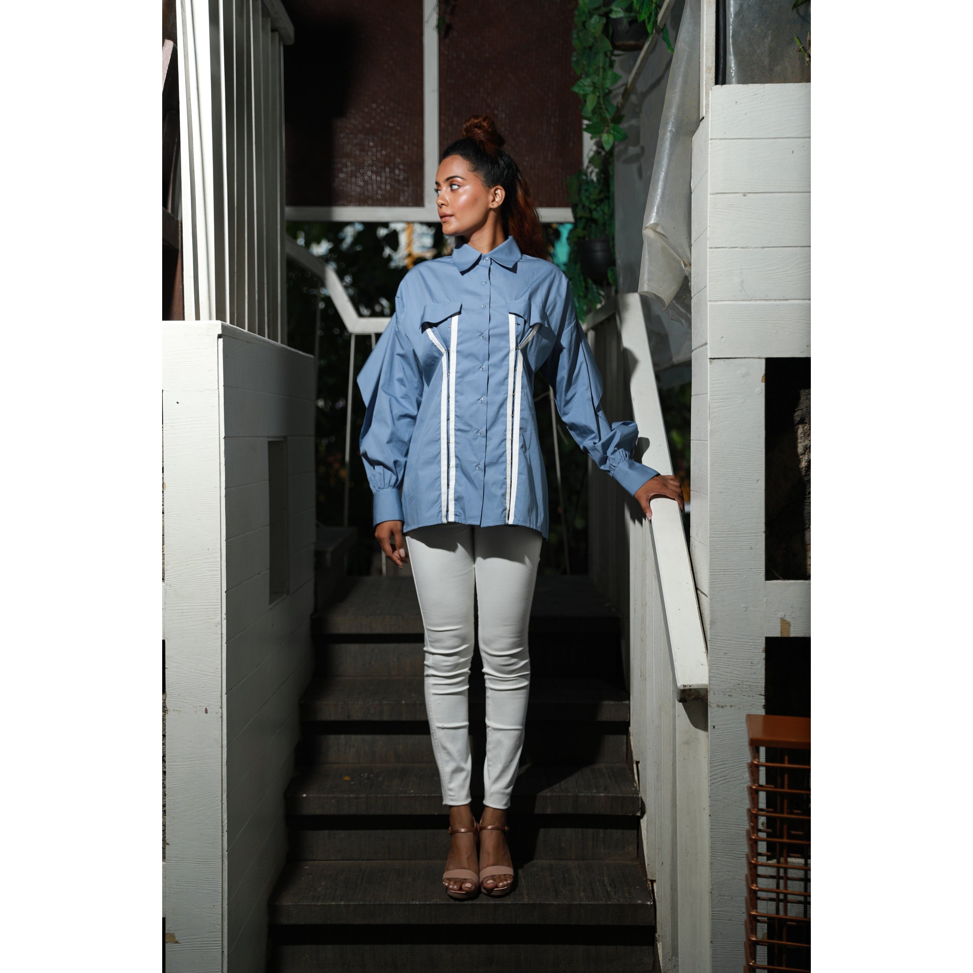 Slate blue wide collared shirt features white piping hook & eye with front dart.