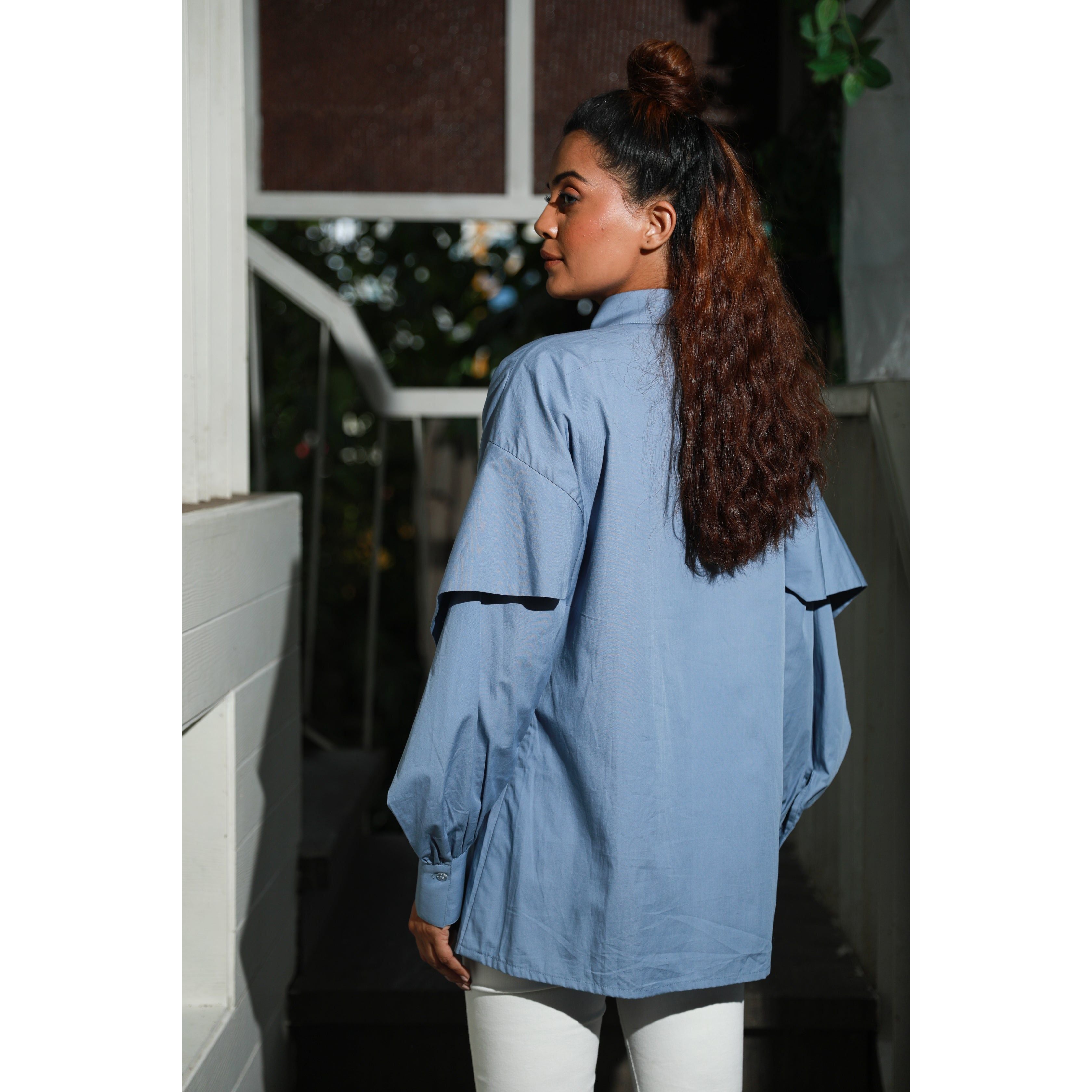 Slate blue wide collared shirt features white piping hook & eye with front dart.